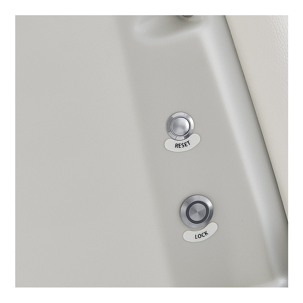 Close-up of RESET and LOCK metal buttons on DIR Sydney Medical Chair – 4 Motors’ light gray surface.