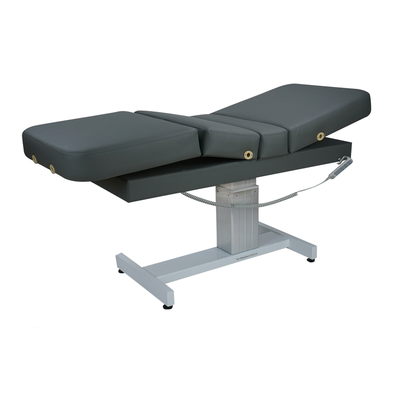 TouchAmerica VENETIAN POWERTILT Table with dark cushions and a sturdy white metal base.