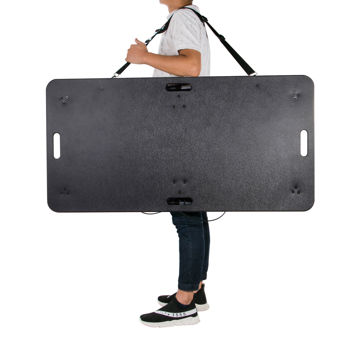 Person carrying Master Massage MARS SPORT Portable Treatment Table with shoulder strap.