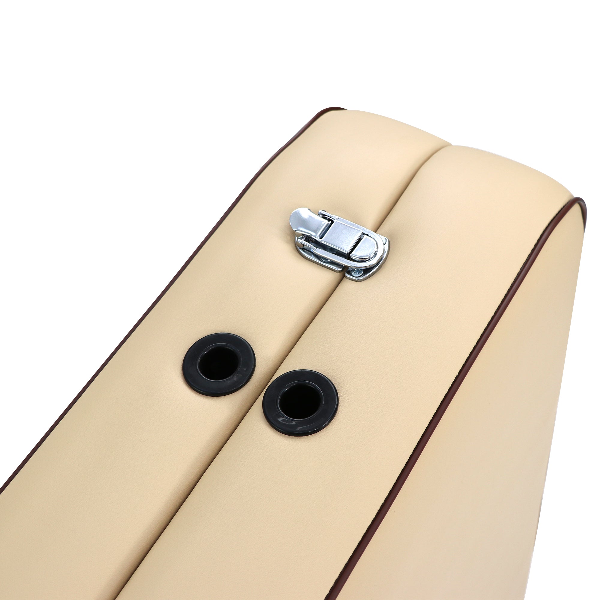 Close-up of a beige Master Massage cushion with black grommets on the Breeze Light portable table.