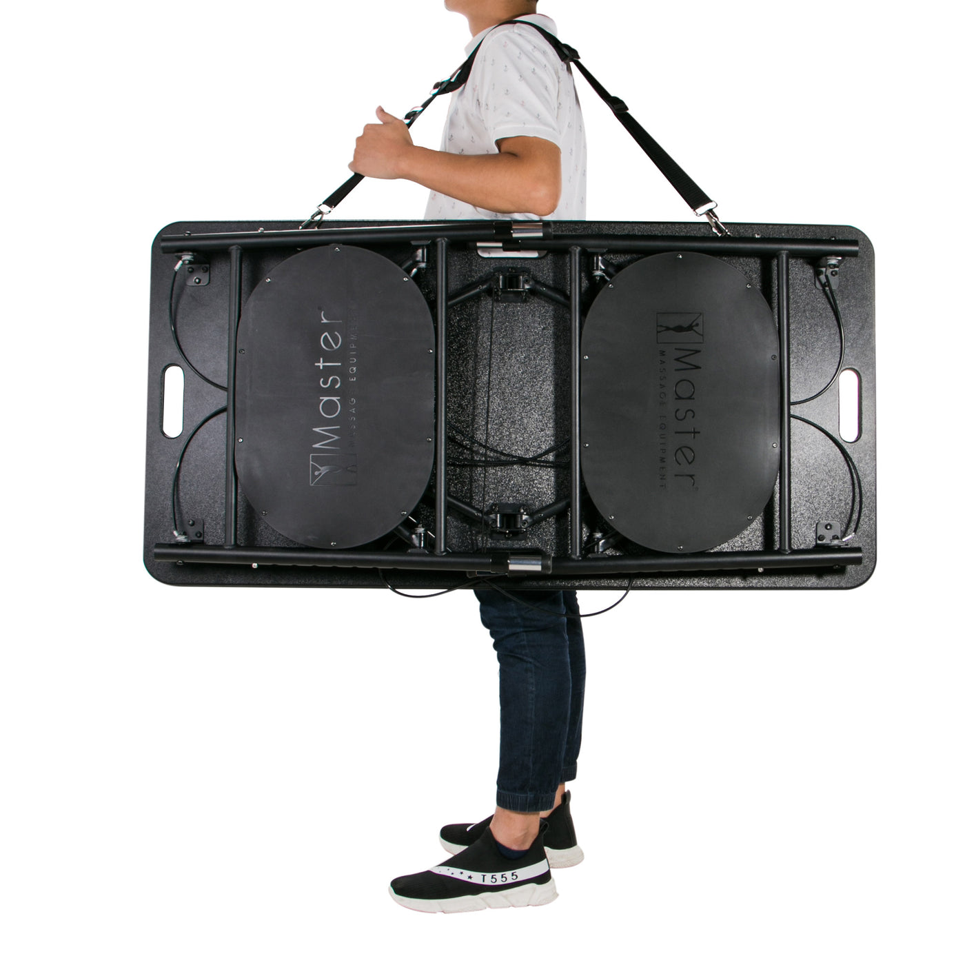 Person carries Master Massage MARS SPORT Table over shoulder with strap.