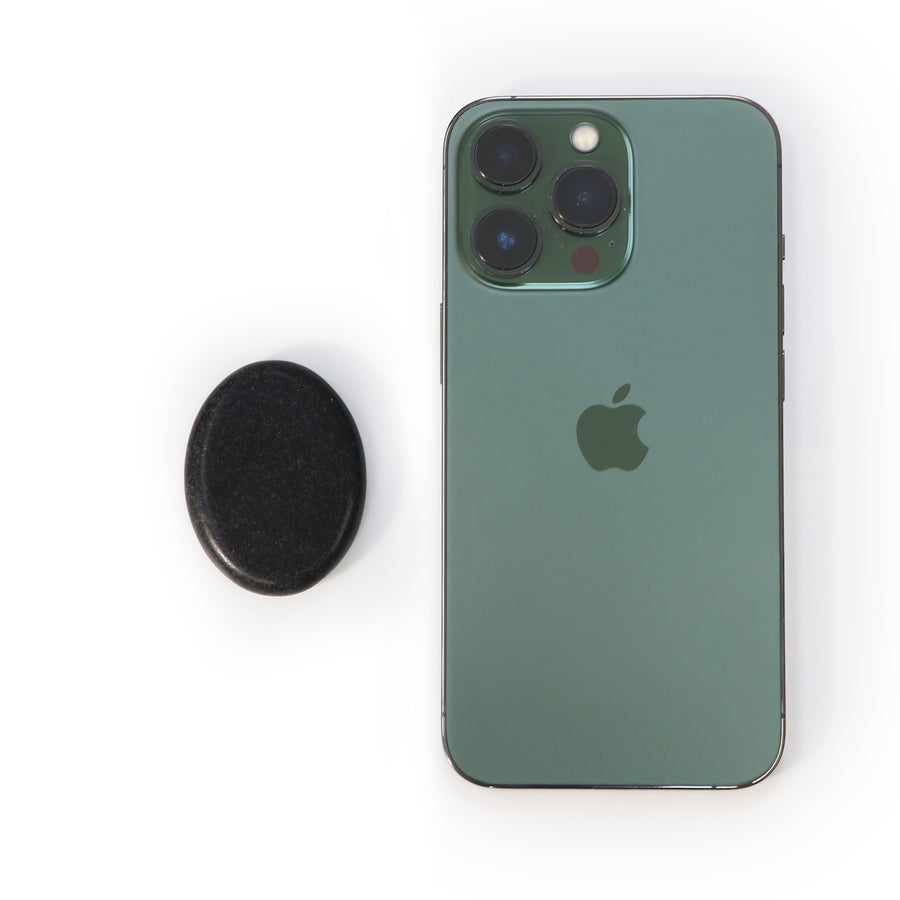 Green smartphone with Apple logo next to a MT Massage Basalt Hot Stone Toe Set 8 Piece Pack on a white background