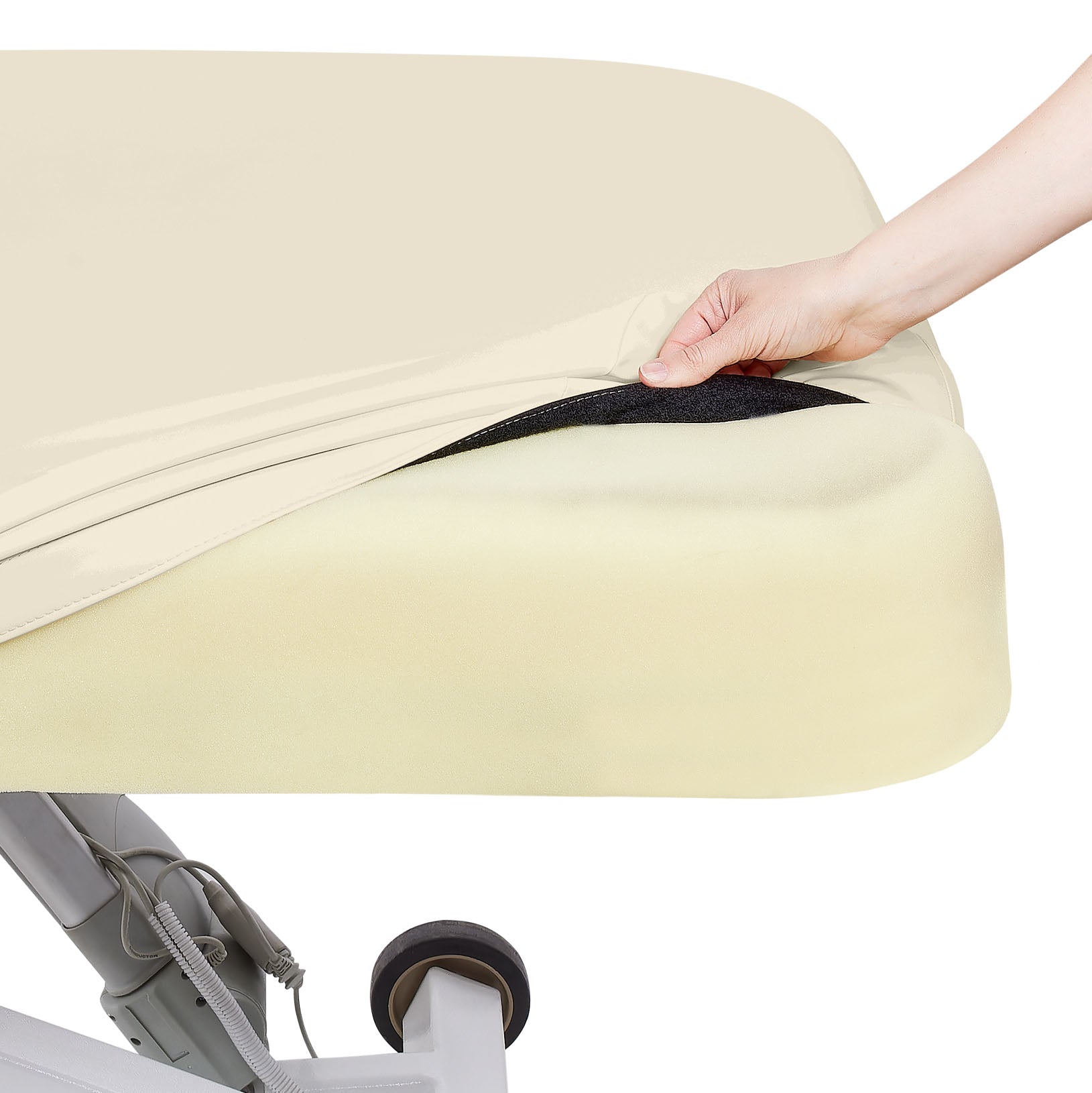 Hand lifting fitted sheet on EarthLite ELLORA LX TILT table with foam mattress and wheel visible.