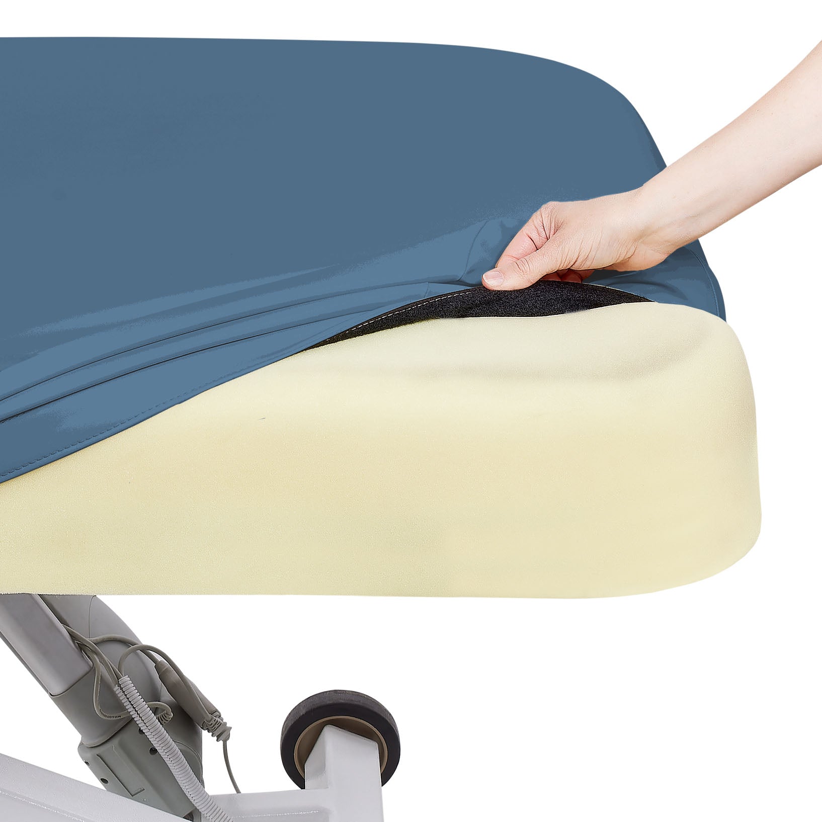A hand lifts a blue cover to reveal EarthLite Strata foam on the ELLORA LX Electric Salon Table.