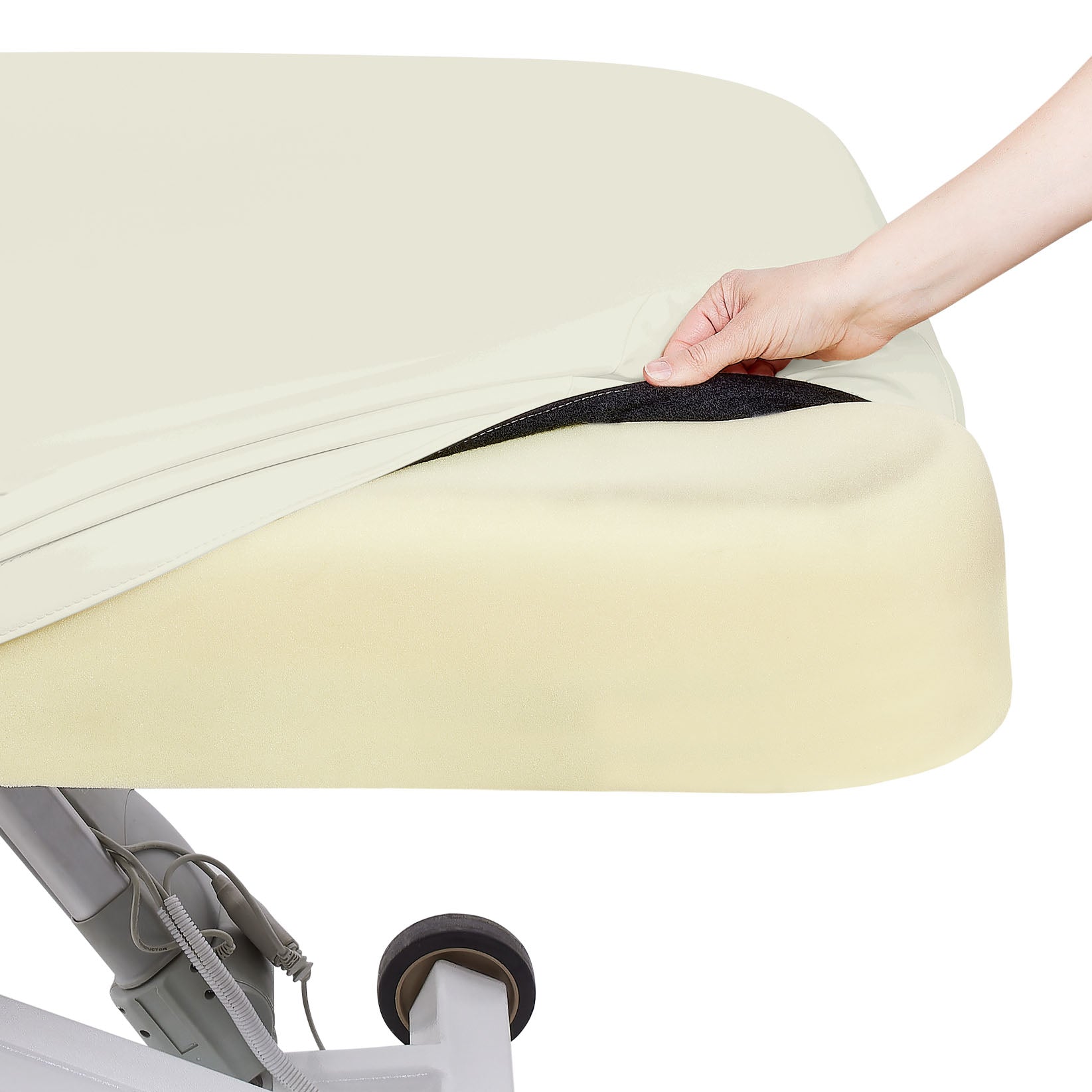 A hand lifts a fitted sheet on the EarthLite ELLORA LX TILT Multi-Purpose Treatment Table.