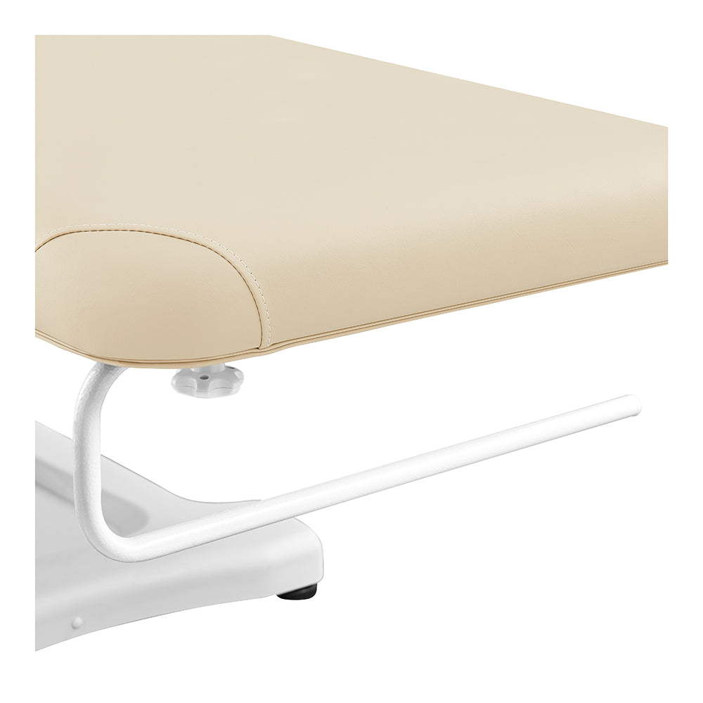 Serenity Electric Treatment Table DIR by DIR with beige cushion and white metal frame, close-up.