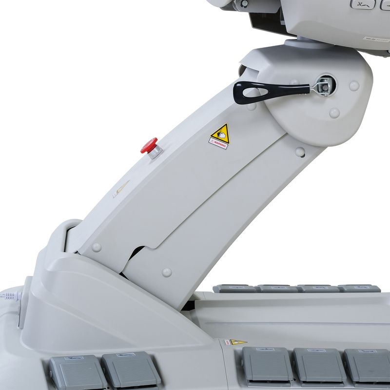 Close-up of a medical imaging machine arm next to a Silverfox America 2246EBN massage chair.