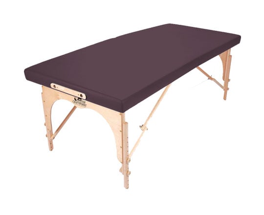 The Custom Craftworks ALEXANDER TECHNIQUE Portable Table features a dark cushion and wood legs.