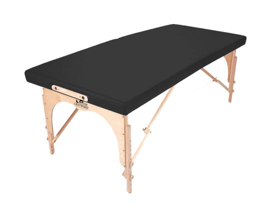 Custom Craftworks ALEXANDER TECHNIQUE portable table with black cushion and light wooden legs.