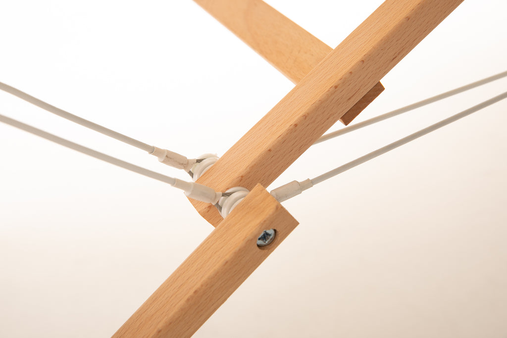 Close-up of Sierra Comfort Premium Wide Table’s wooden joints and bolts, highlighting its mechanism.