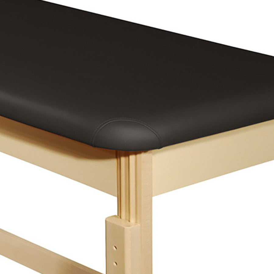 Corner of an MT Massage HARVEY Table with oil- and water-resistant upholstery and light wood frame.