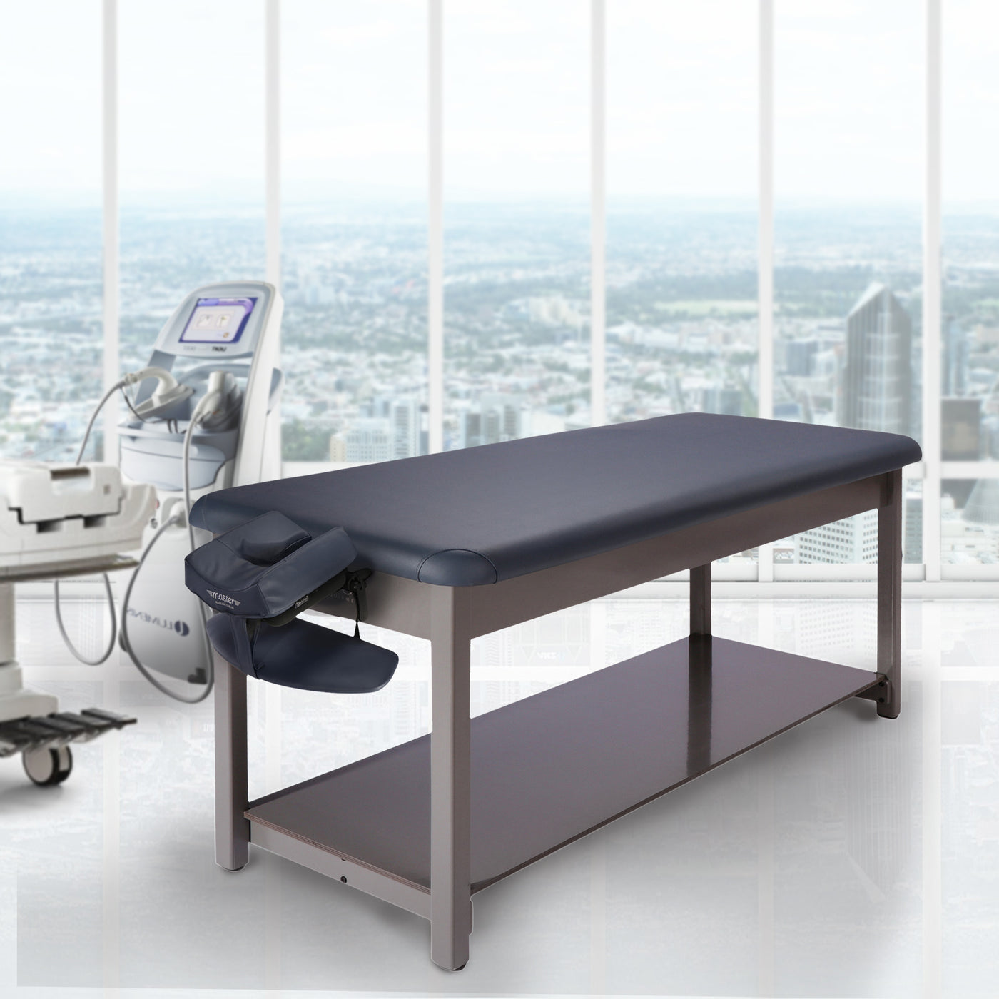 Master Massage Bahama Stationary Table in a medical office with equipment and city view.