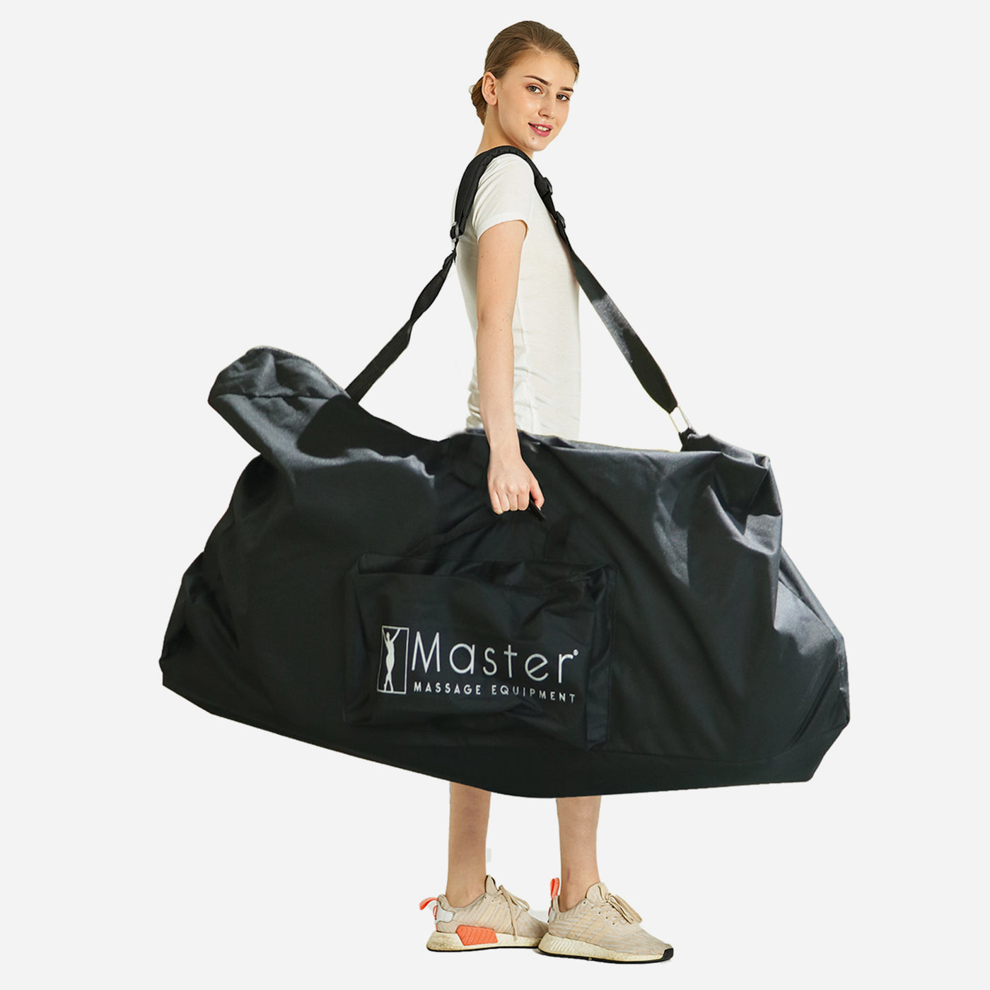 A woman carries the Master Massage BEDFORD Portable Massage Chair Package over her shoulder.