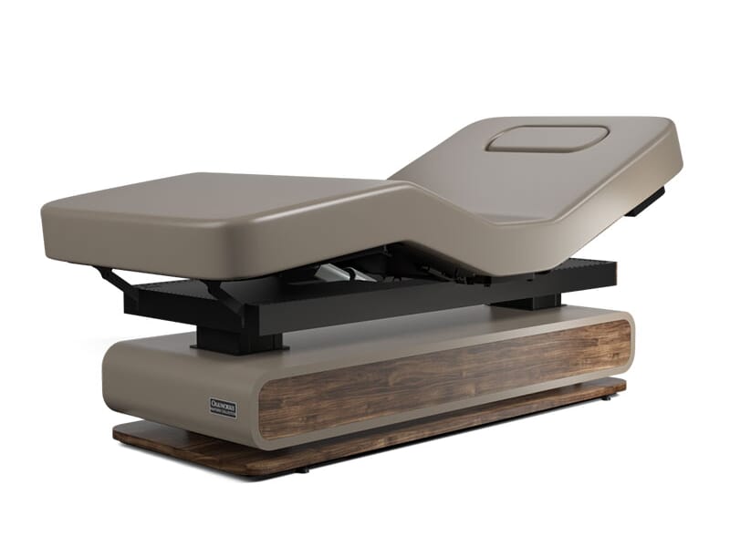 Oakworks Spa BRITTA Table with beige cushioning, wood base, and customizable comfort.