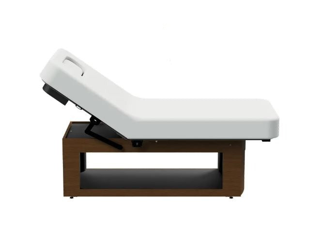 Oakworks Prema E-nvi electric spa table with wooden base and white cushioned top, side view.