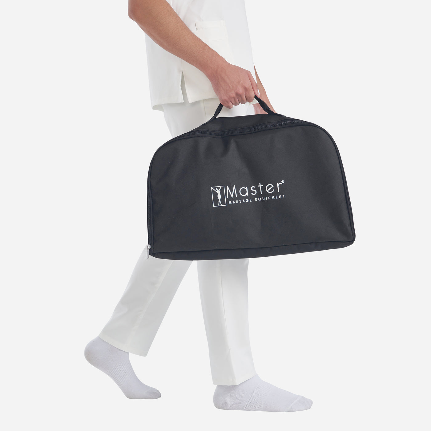 Person holding a black carrying case with 'Master Massage Equipment' logo on a white background