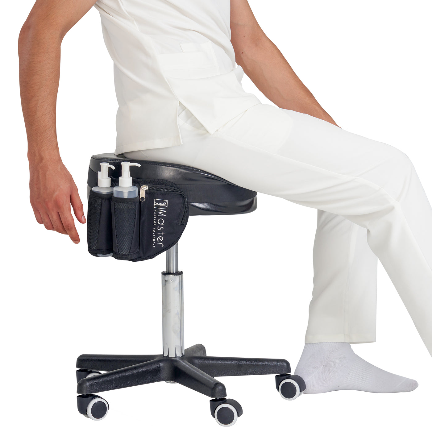Person sitting on a black massage stool with a Master Massage Double Bottle Massage Oil Holster Bag, on a white background