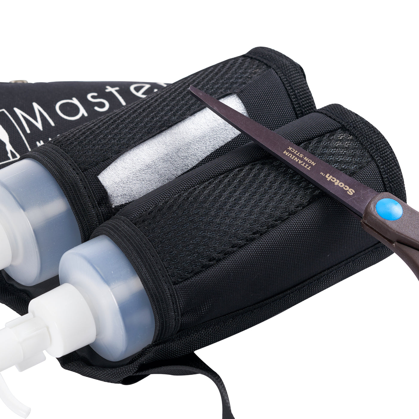 Black sports bag with two bottles and a pair of scissors on a white background