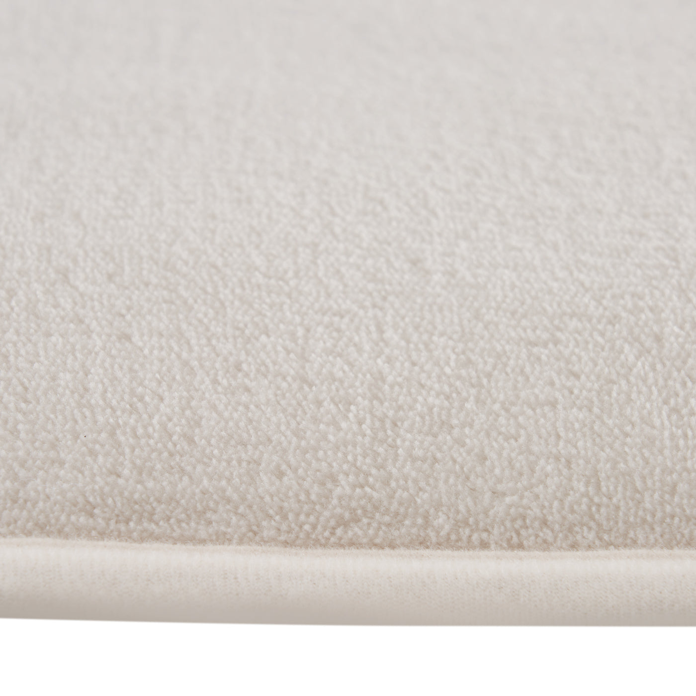 Close-up of textured beige fabric with a white border
