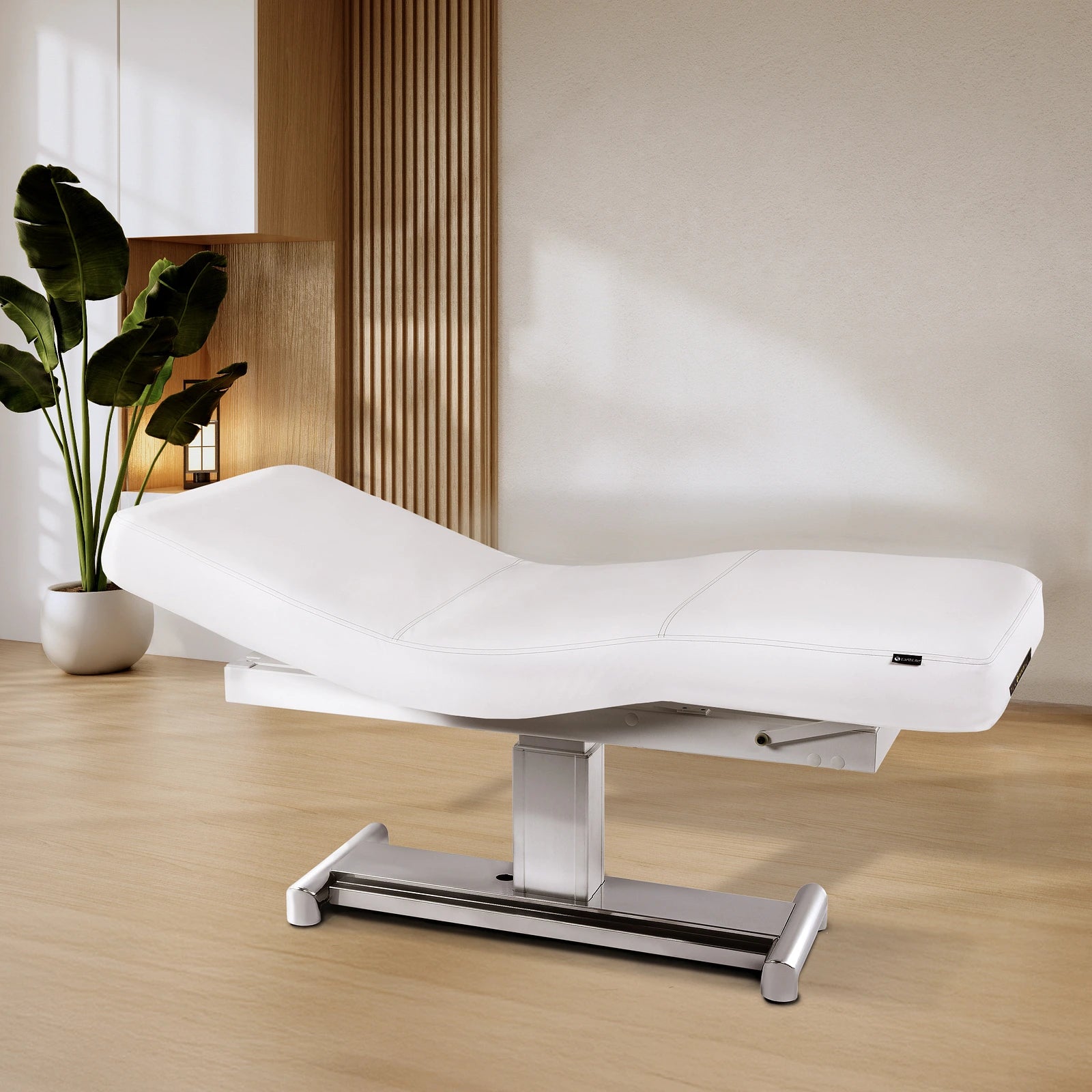 EarthLite EVEREST LX salon table with replaceable mattress in a modern room with wood accents.