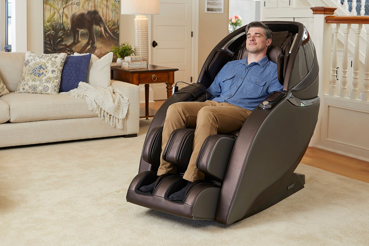 Man relaxing in an Infinity Evo Max 4D Electric Massage Chair (Certified Preowned) at home.