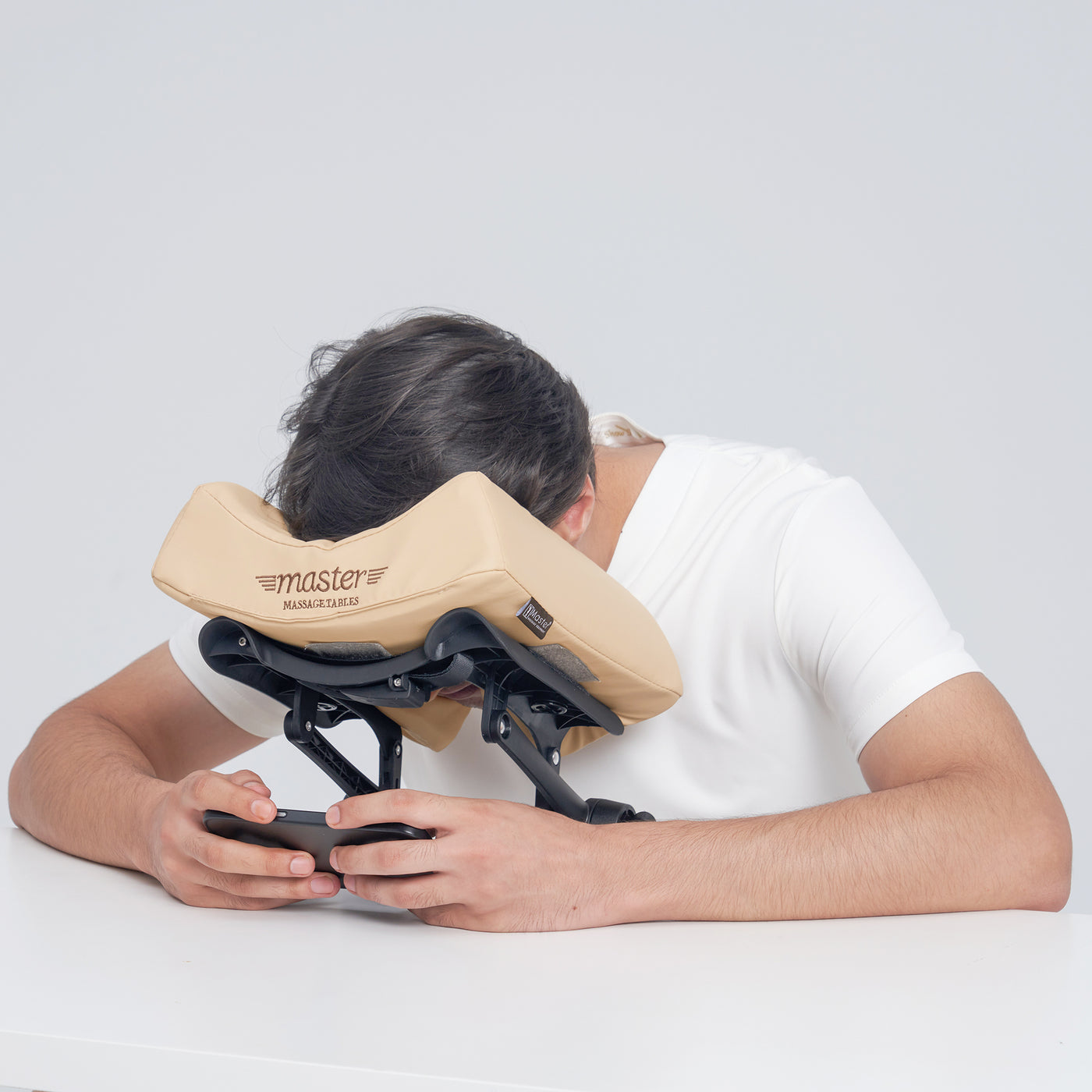 Person using a beige massage pillow with MT ErgoCaptain DELUXE Face Cradle