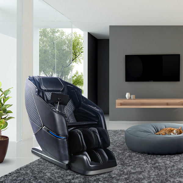 Black massage chair in a modern living room with a TV and pet bed.