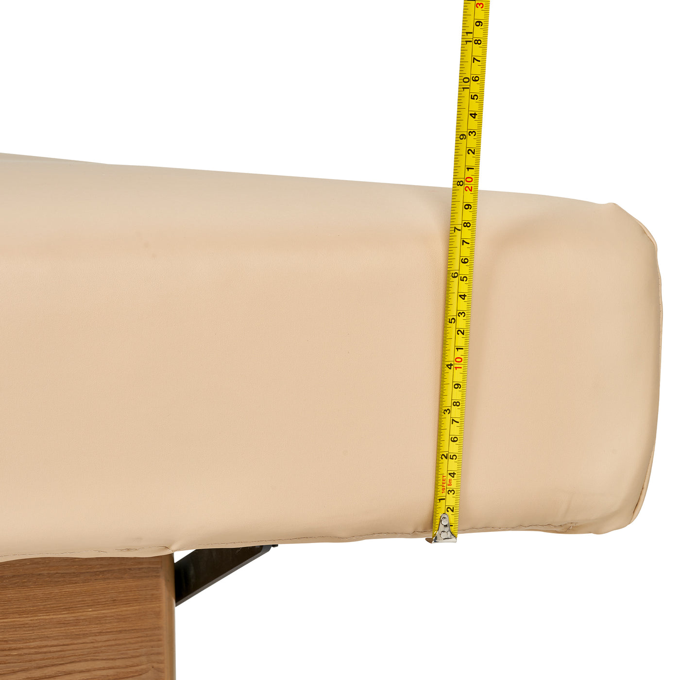 A yellow tape measures the padding on the Master Massage Atlas Flat Electric Lift Bed.