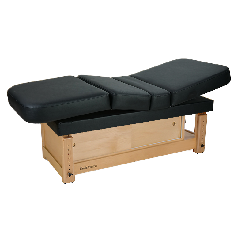 TouchAmerica STATIONARY MULTIPRO black treatment table with padded top and wooden base.