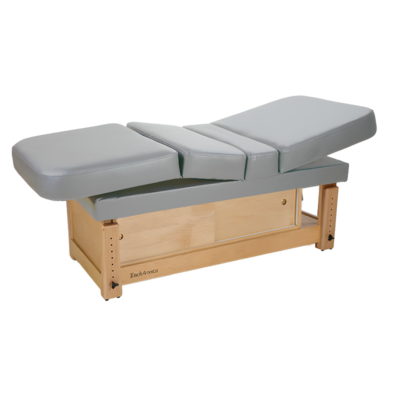 TouchAmerica STATIONARY MULTIPRO Treatment Table with padded sections and wooden base, grey.