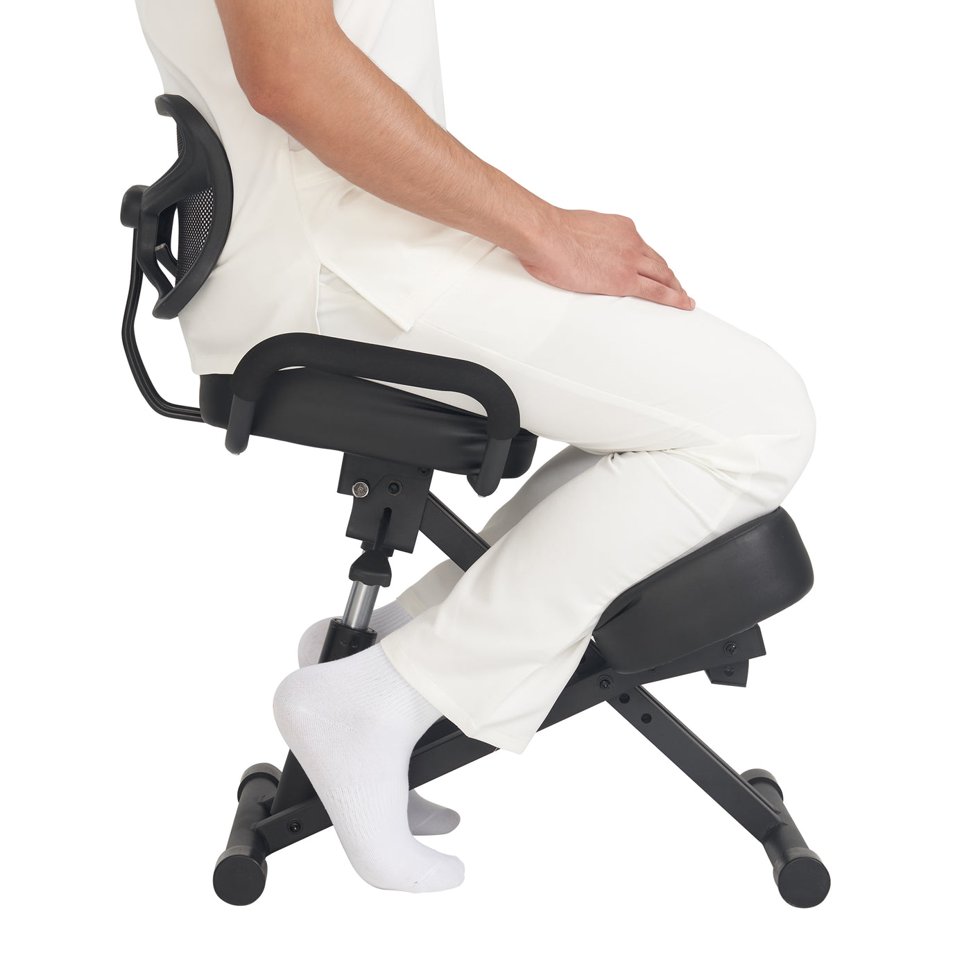 Person sitting on Master Massage Ergonomic Kneeling Chair with Back Support, side view.