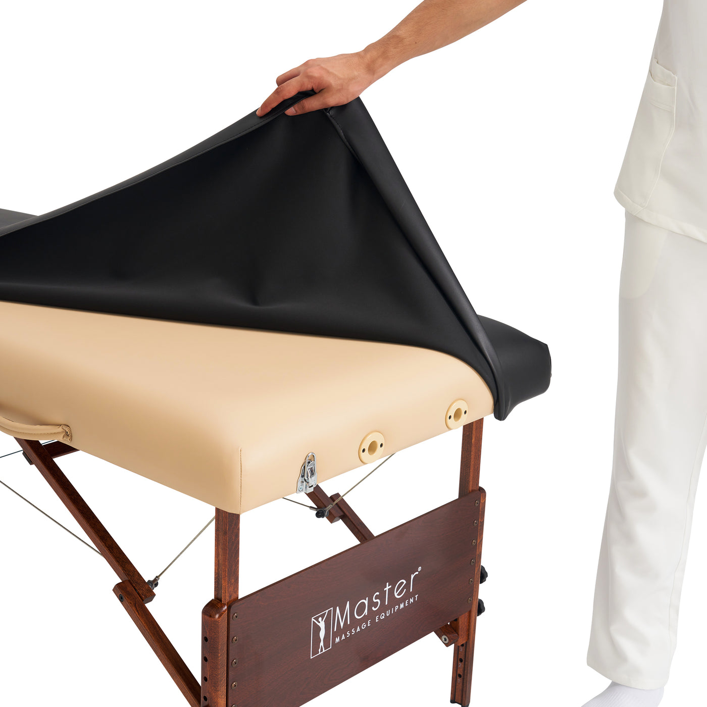 Beige massage table with black cover and 'Master Massage Equipment' branding.