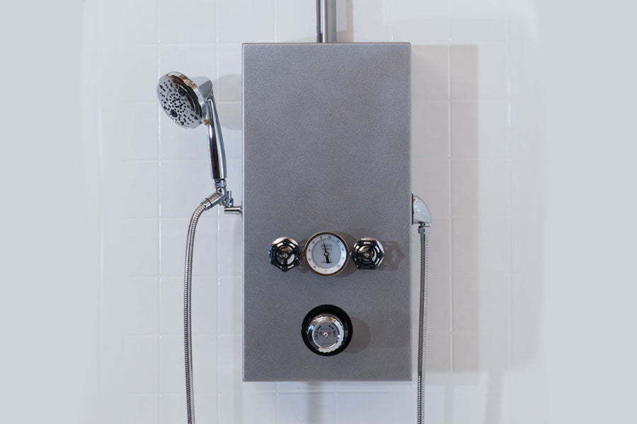 Water Werks Cascade 5 Head Vichy Shower with 85” arm mounted on a white tiled wall.