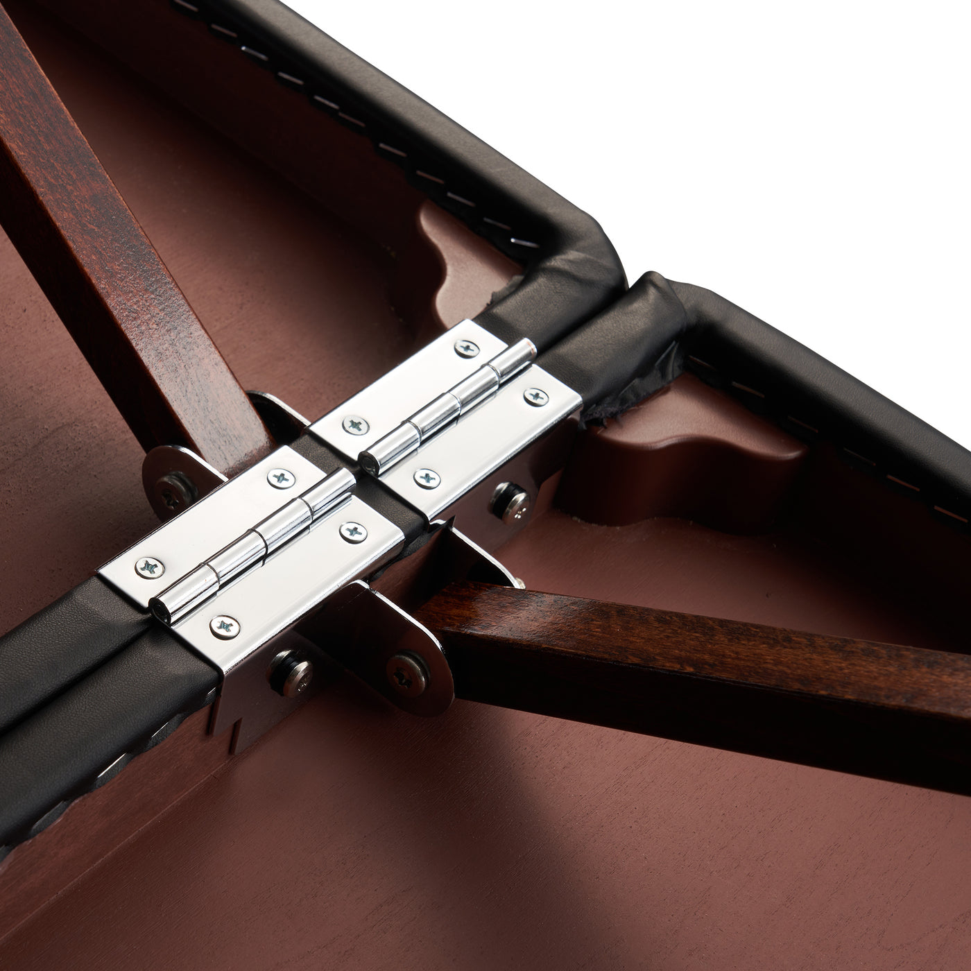 Close-up of metal hinges on the Master Massage Roma II Portable Massage Table’s padded surface.