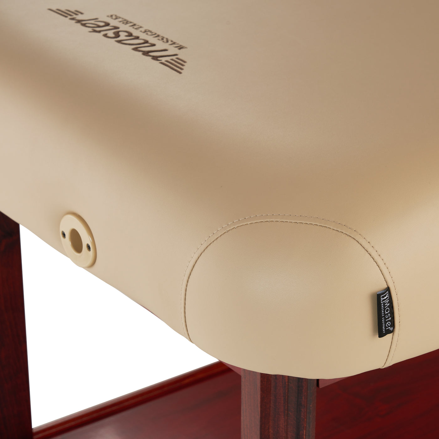 Close-up of Master Massage SPAMASTER beige table corner with wood legs and visible brand tag.