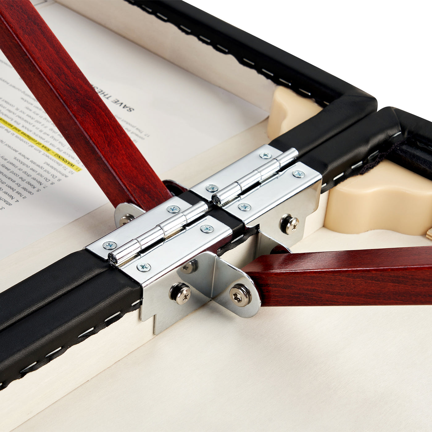 Close-up of Master Massage MONTCLAIR hinges joining wood and padding on Therma Top massage table.