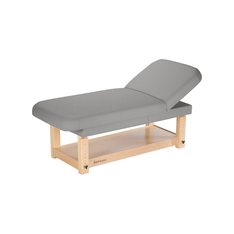 TouchAmerica Stationary Face & Body Treatment Table with maple frame and storage shelf.