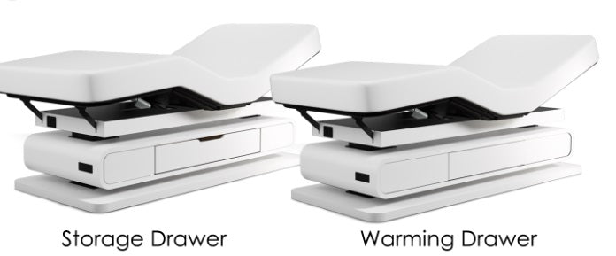 Two Oakworks Spa BRITTA tables: white, labeled storage, warming drawers, adjustable bases.