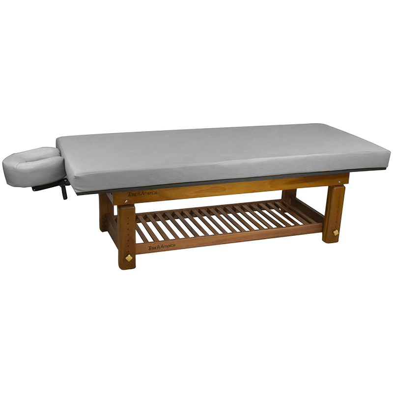 TouchAmerica SOLTERRA teak table with gray cushion, face cradle, and slatted lower shelf.