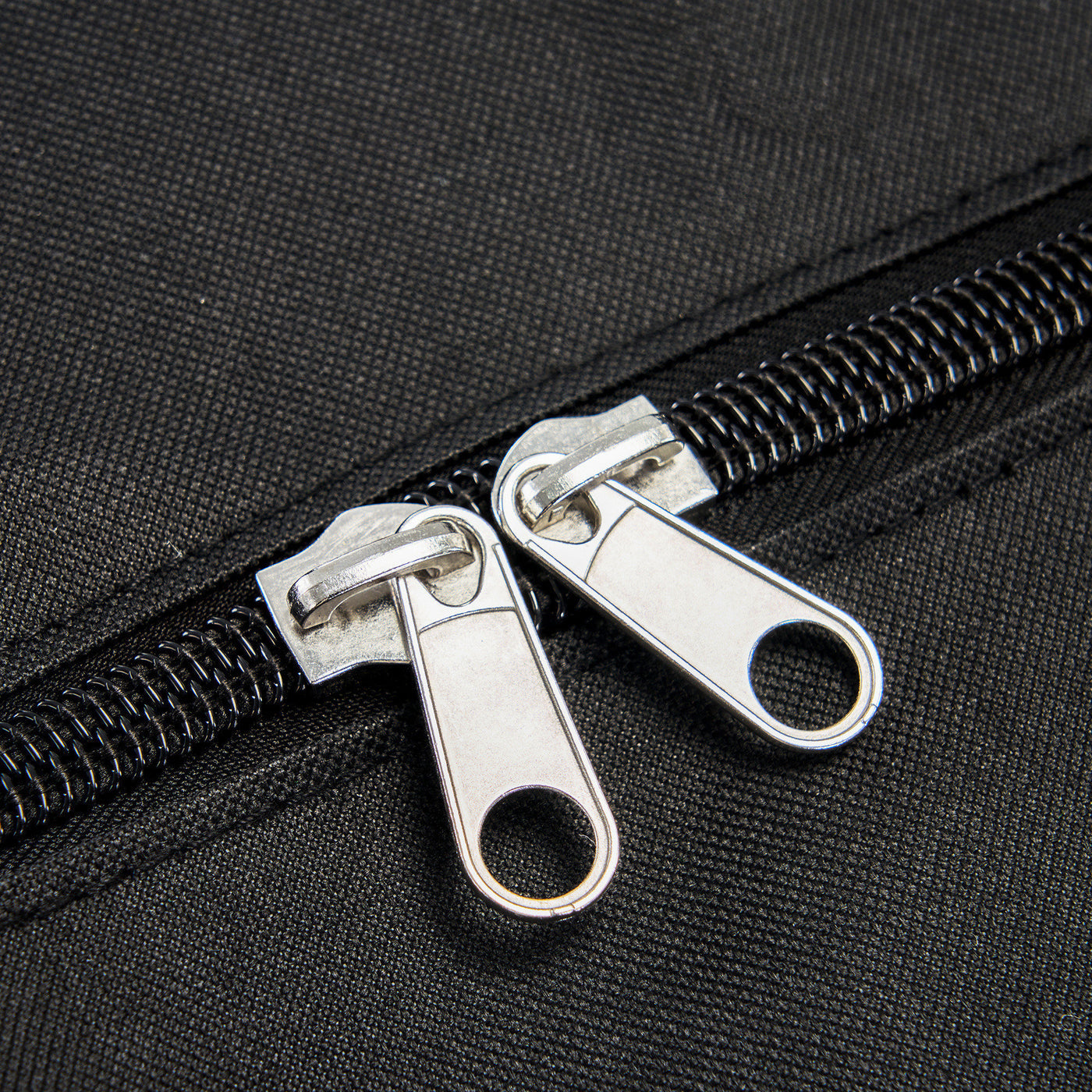 Close-up of a black zipper on a textured surface