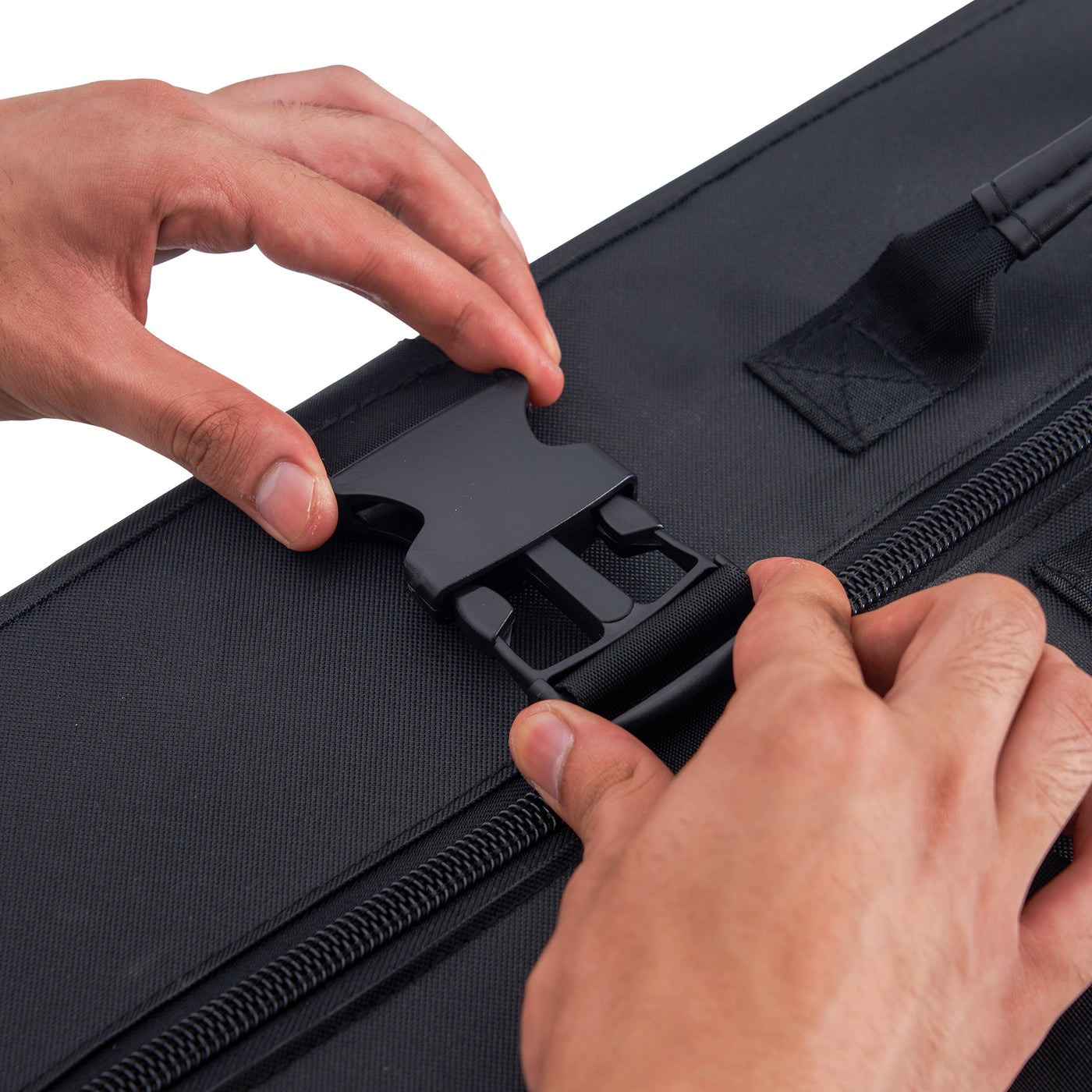 Close-up of hands opening a black carry case with a white background