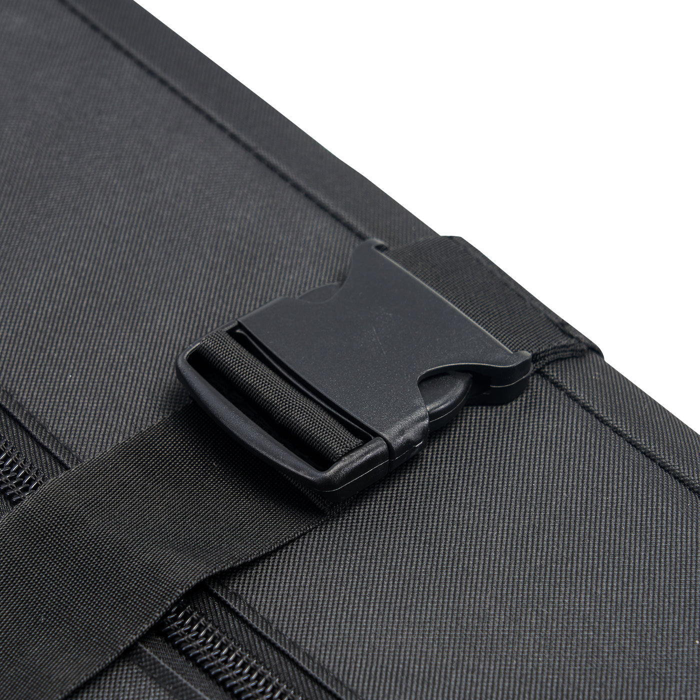 Close-up of a black carry case with a strap and buckle on a white background