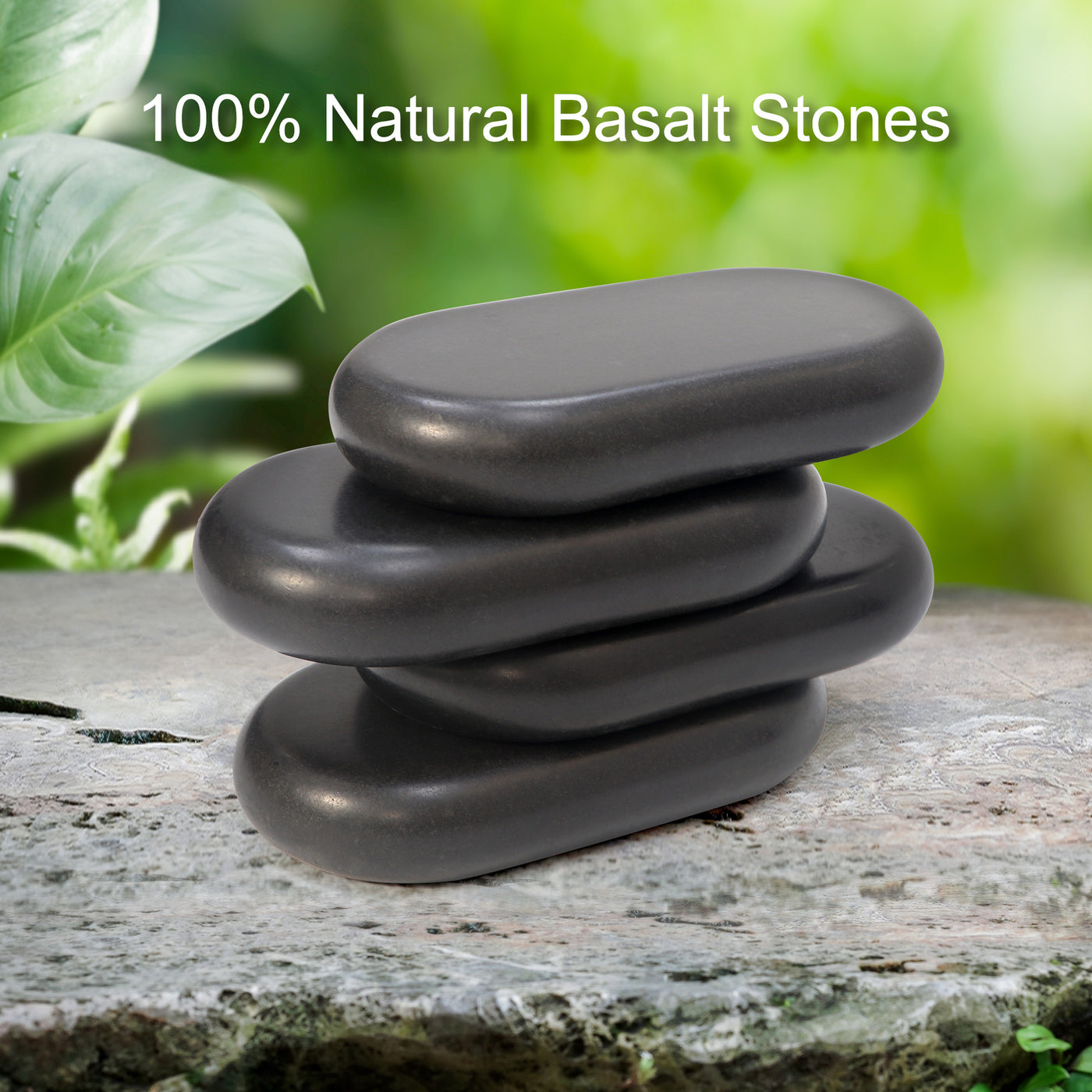 Stack of natural basalt stones on a wooden surface with green foliage in the background