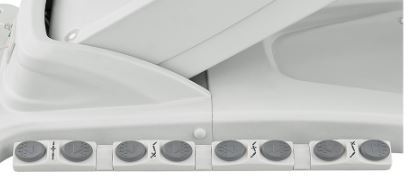Control buttons on a white bidet seat near the DIR Apollo II Electric Beauty Bed with Thermo Heat.