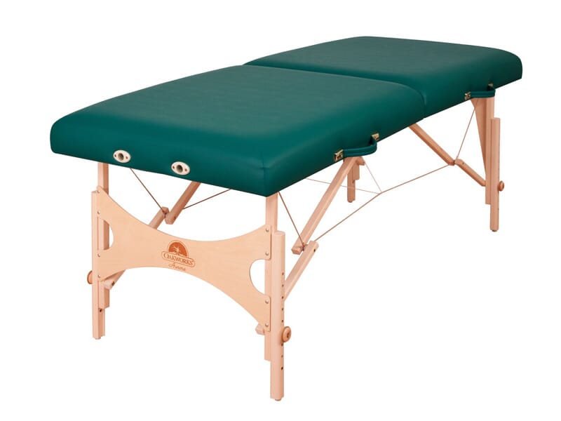 Oakworks AURORA green portable massage table with wood legs, shown on a white background.