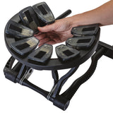 Hand holding a black exercise device with multiple foot pedals on a white background