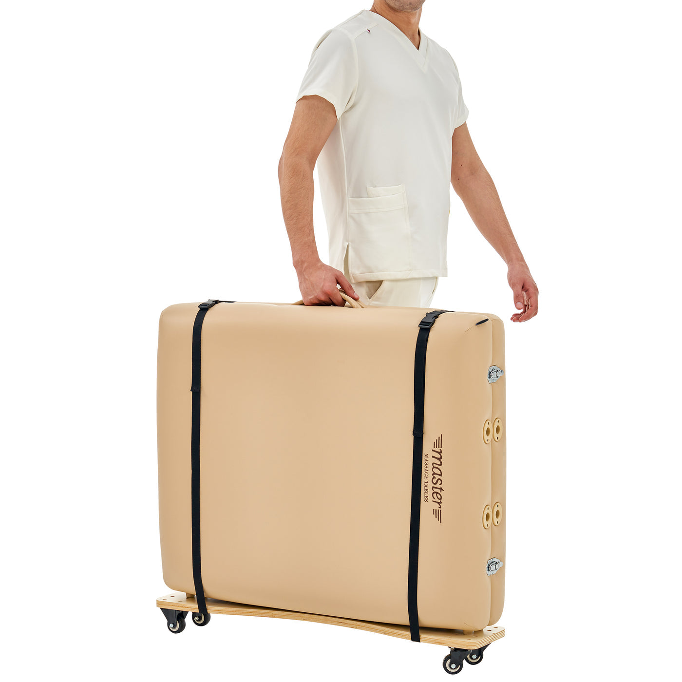 Person holding a beige massage table with black straps on a white background