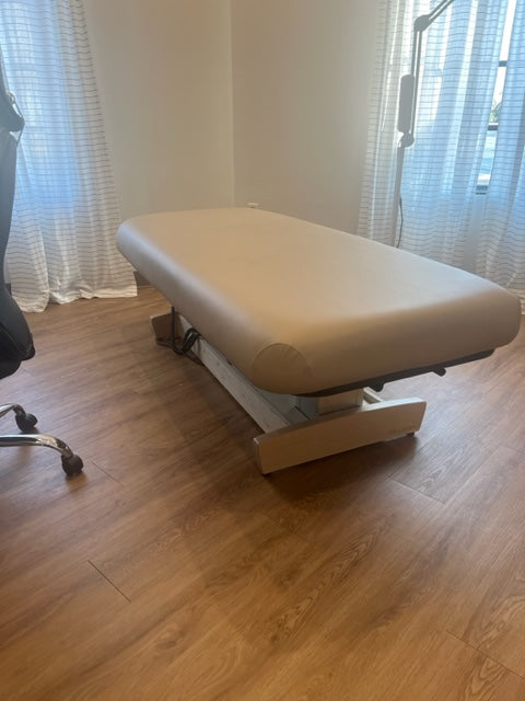 Oakworks PERFORMALIFT Flat Top table in a room with wood floors and white curtains.