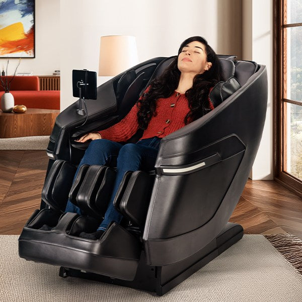 Woman using a massage chair in a modern living room.