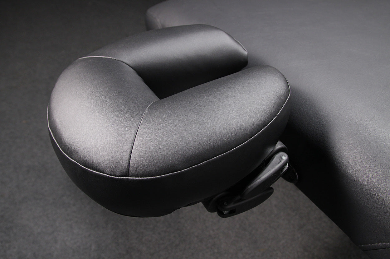 Close-up of a black padded face cradle on a Hill Laboratories Massage Electric Lift Table.